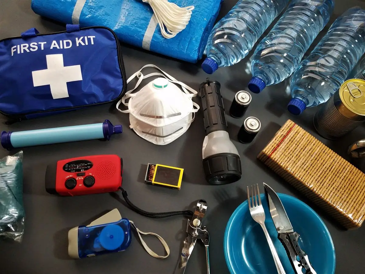 Flat lay of emergency preparedness objects including first aid and water bottles.
