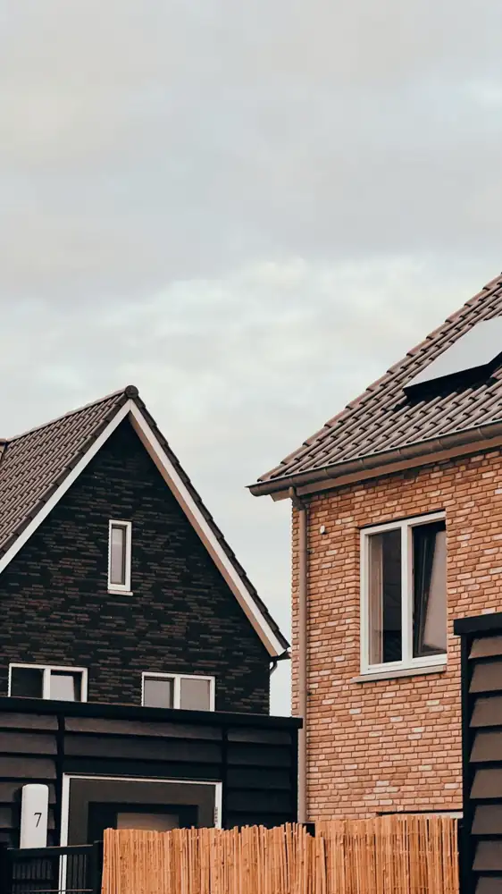 Close-up of modern homes with distinctive architecture under an overcast sky