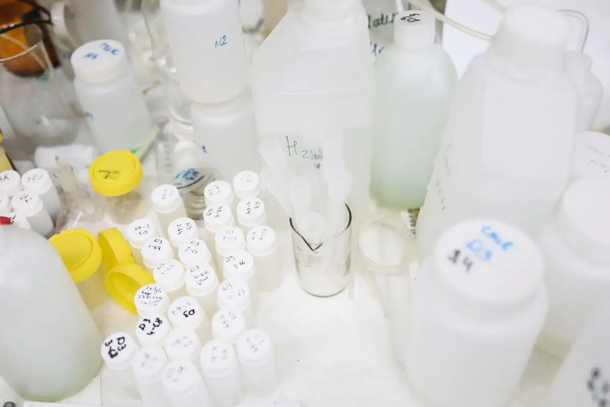 Collection of plastic bottles and containers in a laboratory setting, used for scientific research.
