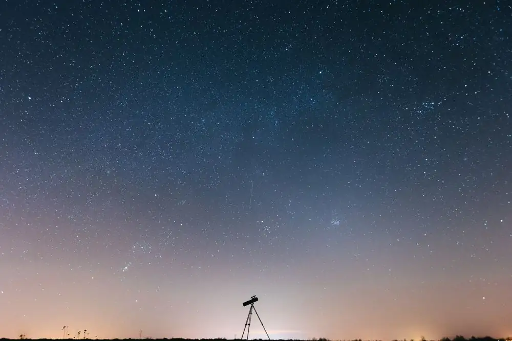Stunning night sky filled with stars and a silhouette of a telescope.