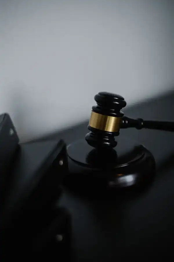 Black wooden gavel beside organized document folders