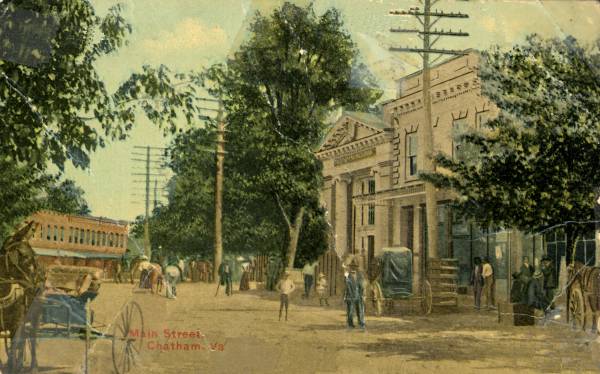 Historic hand-colored postcard showing Chatham storefronts, pedestrians, and horse-drawn wagons along North Main Street.